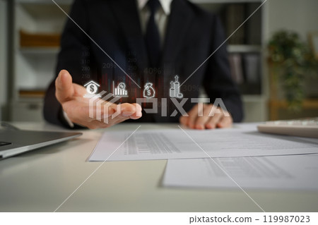 Professional businessman presenting investment options with virtual icons 119987023