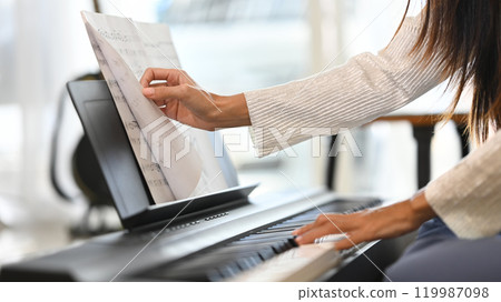 Female musician enjoying her music practice in cozy living room Female musician enjoying her music practice in cozy living room 119987098