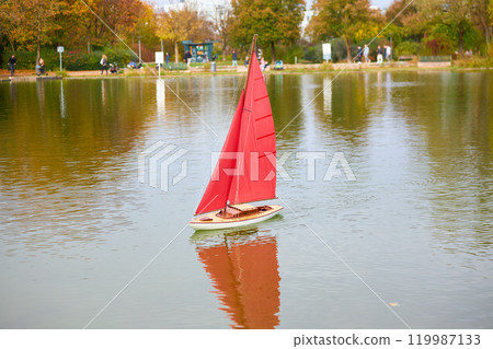 Quiet Boat Floating on a Lake in a Green Park 119987133