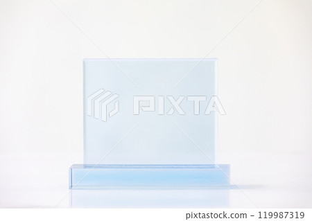 The shot of the blank transparent glass award trophy on a white background, the custom laser cut of the transparent crystal prize. The shot of the blank transparent glass award trophy on a white background, the custom laser cut of the transparent crystal prize. 119987319