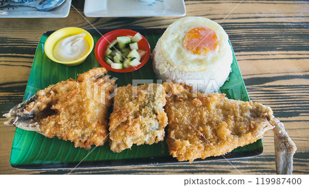 A plate of authentic local Filipino breakfast meal called bangsilog which is battered milkfish served with sinangag or garlic fried rice and egg 119987400