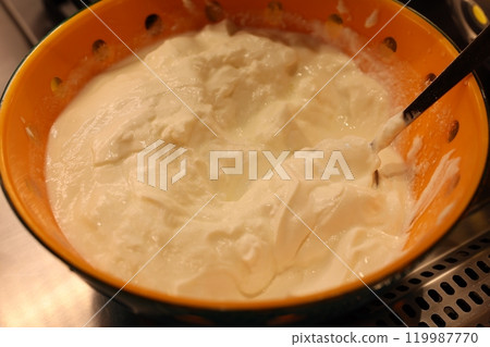 A bowl filled with a creamy white mixture, perfect for various culinary creations A bowl filled with a creamy white mixture, perfect for various culinary creations 119987770