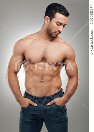 Man, body and thinking in studio with muscles or abs, shirtless and grey background with model or bodybuilder. Jeans, strong chest and Asian male person on backdrop, confidence with six pack 119988174