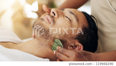 Facial, beauty and man with gua sha treatment for massage, spa aesthetic and skincare benefits for circulation. Guy, dermatology and therapist hand with stone tool for wellness and lymphatic drainage Facial, beauty and man with gua sha treatment for massage, spa aesthetic and skincare benefits for circulation. Guy, dermatology and therapist hand with stone tool for wellness and lymphatic drainage 119988290