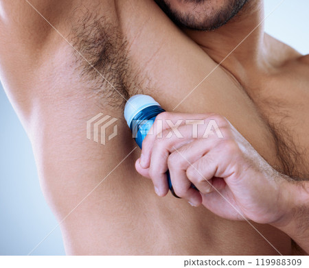 Man, armpit and deodorant in studio for wellness, hygiene and fresh for self care with scent. Roll on, skincare and male person by white background for cologne, cosmetics and morning routine Man, armpit and deodorant in studio for wellness, hygiene and fresh for self care with scent. Roll on, skincare and male person by white background for cologne, cosmetics and morning routine 119988309