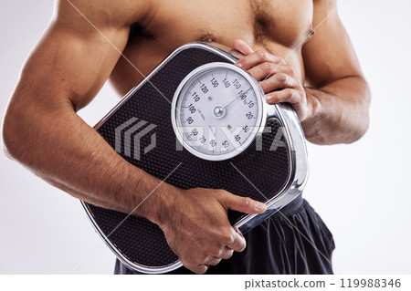 Man, muscle and fitness holding scale in studio white background for workout, exercise and weight loss. Male person, wellness and health progress check for training, self care and bodybuilding 119988346