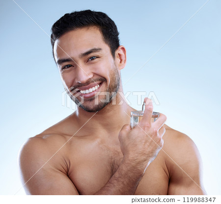 Man, portrait and perfume in studio for wellness, hygiene and happy for self care with pride. Deodorant, scent and male person by white background for cologne, cosmetics, skincare and routine 119988347