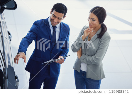 Salesman, dealership and woman in showroom for retail, shopping and investment for vehicle. Business, clipboard and customer with smile for sale, discount and choice with transportation for purchase Salesman, dealership and woman in showroom for retail, shopping and investment for vehicle. Business, clipboard and customer with smile for sale, discount and choice with transportation for purchase 119988541