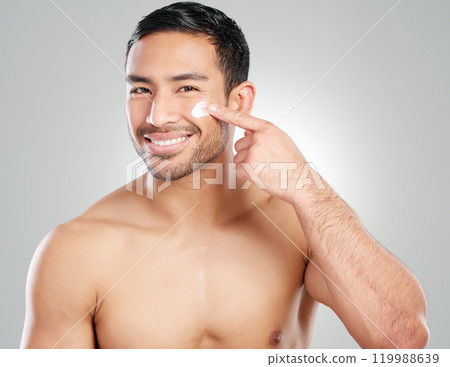 Portrait, smile and man with cream, skincare and dermatology on white studio background. Face, person and model with cosmetics, beauty or creme for healthy skin, lotion and wellness with facial 119988639