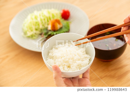Middle-aged to senior women eating a hamburger steak set meal 119988643