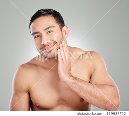Skincare, health and portrait of man in studio with natural, beauty and facial wellness for confidence. Cosmetic, hygiene and person with face dermatology for morning treatment by gray background. Skincare, health and portrait of man in studio with natural, beauty and facial wellness for confidence. Cosmetic, hygiene and person with face dermatology for morning treatment by gray background. 119988722