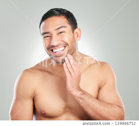 Asian man, skincare and washing face for grooming, hygiene and hydration in studio. Happy, male person and smile with cleaning or facial treatment for wellness and beauty on white background 119988752