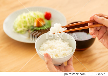 Middle-aged to senior women eating a hamburger steak set meal 119988774