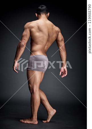 Man, underwear and body muscle in studio for fitness, workout or training isolated on black background. Back, bodybuilder and topless person with strong legs, feet and wellness for healthy exercise Man, underwear and body muscle in studio for fitness, workout or training isolated on black background. Back, bodybuilder and topless person with strong legs, feet and wellness for healthy exercise 119988790
