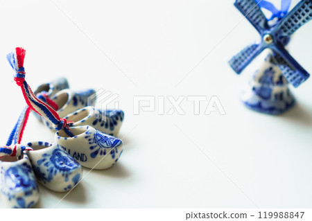 Christmas ornaments, Dutch Delft pottery, blue wooden shoes and windmill, white background 119988847
