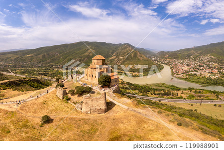 Aerial top view of ancient Jvari Monastery is a VI century Georgian Orthodox monastery. Holy Cross church is Early Medieval Georgian. Confluence of Kura and Aragvi. Tbilisi, Mtskheta, Georgia, Europe. Aerial top view of ancient Jvari Monastery is a VI century Georgian Orthodox monastery. Holy Cross church is Early Medieval Georgian. Confluence of Kura and Aragvi. Tbilisi, Mtskheta, Georgia, Europe. 119988901