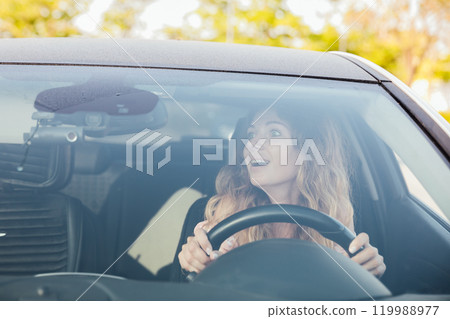 Beautiful woman driving a car on the road Beautiful woman driving a car on the road 119988977