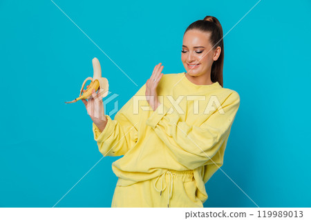 Beautiful woman doesn't like to eat banana 119989013