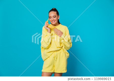 Woman talking on banana like on the phone 119989015