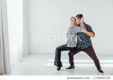 Man and woman dancing together to bachata music Man and woman dancing together to bachata music 119989149