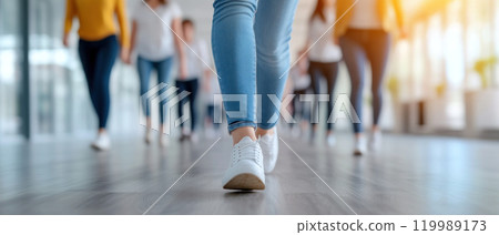 Confident individuals walking together in modern office space Confident individuals walking together in modern office space 119989173