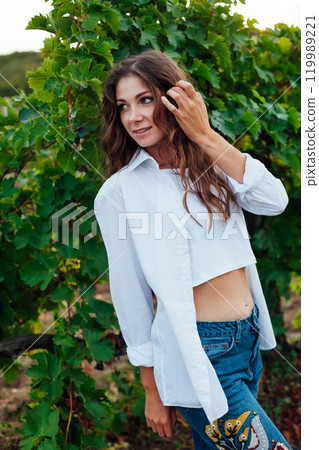 Beautiful woman walking in vineyard before harvest 119989221