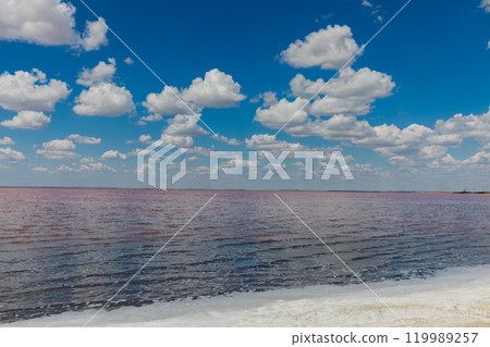 Beautiful landscape, salty pink lake and blue sky with clouds Beautiful landscape, salty pink lake and blue sky with clouds 119989257