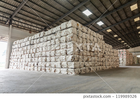 The natural Thai standard rubber bales sheet products staked and stored in the factory warehouse. The storage procession product of a rubber factory. The natural Thai standard rubber bales sheet products staked and stored in the factory warehouse. The storage procession product of a rubber factory. 119989326