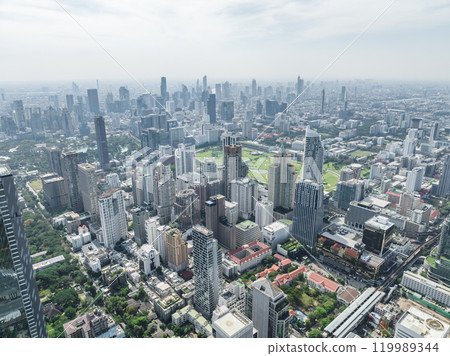 The bustling city of Bangkok comes alive in the daytime, as towering skyscrapers and a vibrant urban landscape paint a captivating scene. 119989344