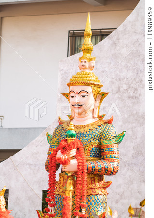 Majestic statue of Thao Wessuwan, the Asian deity of wealth and protection, showcased in the sacred surroundings of Wat ThepLeeLa temple in Bangkok, Thailand. 119989359
