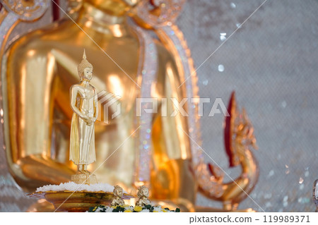 A stunning golden Buddha sculpture, exemplifying the deep reverence and devotion of Thai individuals in their spiritual worship. A stunning golden Buddha sculpture, exemplifying the deep reverence and devotion of Thai individuals in their spiritual worship. 119989371