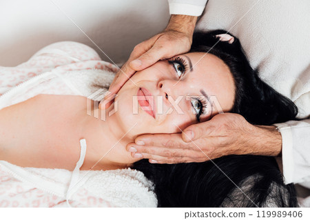 Man and woman in pajamas hugging family in bedroom Man and woman in pajamas hugging family in bedroom 119989406