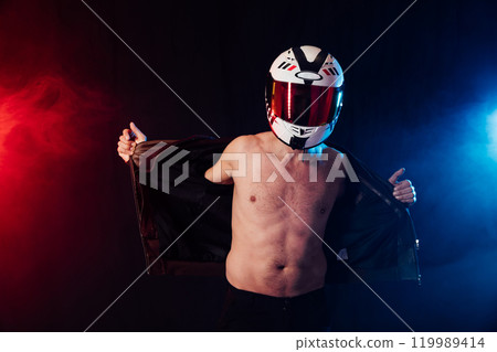 Man in a motorcycle helmet on a bare torso Man in a motorcycle helmet on a bare torso 119989414