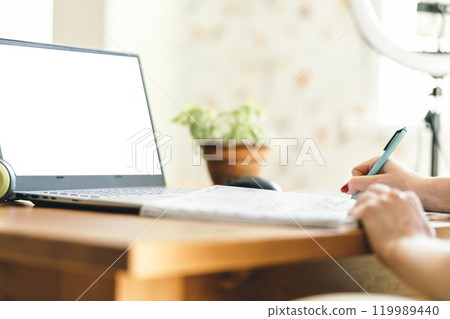 Creating a Productive Study Environment at Home, women's hands with a notebook and pen at the table Creating a Productive Study Environment at Home, women's hands with a notebook and pen at the table 119989440