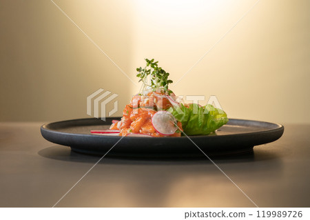 Spicy Raw Salmon Salad Thai food style decorated with Crispy fried fish skin and Yellow Flower on top and micro herb around dish. Ready to serve and eat. Spicy Raw Salmon Salad Thai food style decorated with Crispy fried fish skin and Yellow Flower on top and micro herb around dish. Ready to serve and eat. 119989726