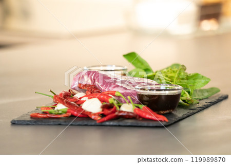 Close up, Raw Beef herb ingredients, basil, garlic, chilli, sauces are prepared on black slate plate for cooking Thai food menu, Stir-fried beef basil. Close up, Raw Beef herb ingredients, basil, garlic, chilli, sauces are prepared on black slate plate for cooking Thai food menu, Stir-fried beef basil. 119989870