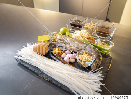 Pad Thai, a Thai traditional dish, is a Stir Fried Noodle with shrimp, noodle, tofu, bean sprout, cayenne, spring onion, peanuts, groundnut, and vegetable with a special sauce. 119989875