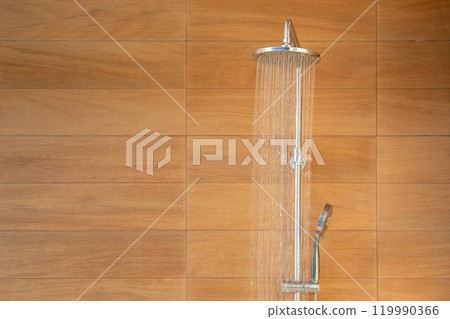 Outdoor shower head for the bath and showering cold water to body before jumping in the resort pool. 119990366