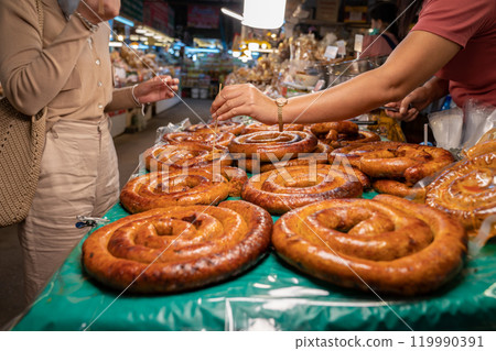 Sai Aua, Northern Thailand Spicy Sausage is a famous Traditional Local saurage cooked with curry and herb, lay on shop and ready for sales. Sai Aua, Northern Thailand Spicy Sausage is a famous Traditional Local saurage cooked with curry and herb, lay on shop and ready for sales. 119990391