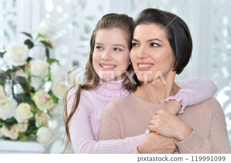 Little girl with her mother posing at home 119991099