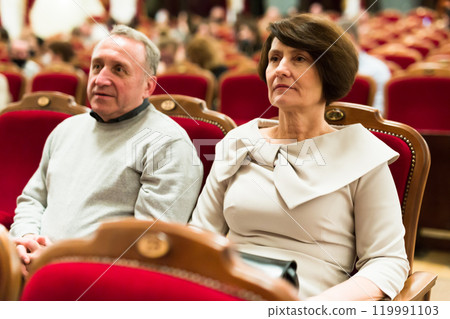 Elderly couple watching play in the theater 119991103