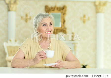 Beautiful elderly woman drinking coffee at home 119991104