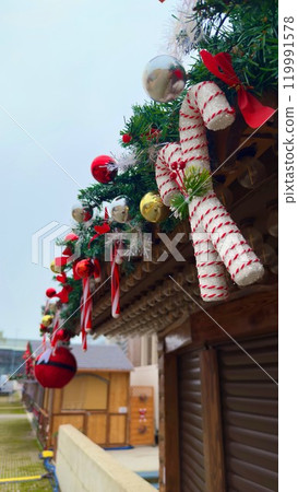 Festive Christmas Market Stall Decorated With Holiday Garland 119991578
