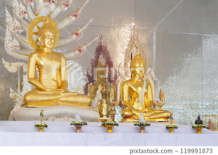 A stunning golden Buddha sculpture, exemplifying the deep reverence and devotion of Thai individuals in their spiritual worship. 119991873