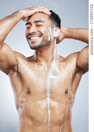 Hygiene, man and washing hair for cosmetics, grooming and self care or cleaning studio grey background. Wellness, male person and water with shampoo showering for body health and haircare with foam 119992328