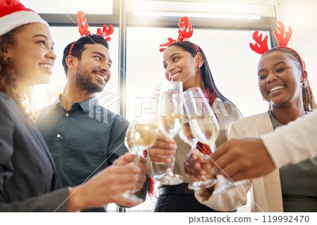 Christmas, toast and friends with alcohol in office for party celebration, social gathering and company lunch. Happy team, diversity and group of people with champagne for festival, cheers or holiday Christmas, toast and friends with alcohol in office for party celebration, social gathering and company lunch. Happy team, diversity and group of people with champagne for festival, cheers or holiday 119992470