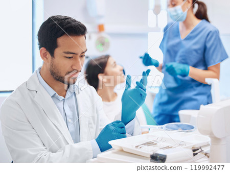 Dentist, man and tools for oral health with nurse in dental care and hygiene in office or consultation in clinic. Doctor, equipment and orthodontist as medical professional in hospital for treatment 119992477