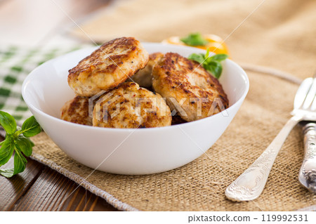 fried chicken cutlets in a bowl on a wooden table fried chicken cutlets in a bowl on a wooden table 119992531