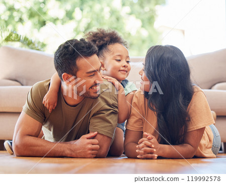 Relax, child and parents on floor for support, development and love or care in family home. Smile, young girl and together in living room for happiness with mother, father and safety in lounge 119992578