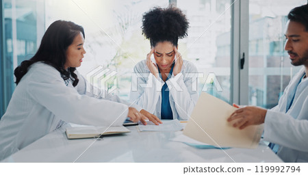 Headache, doctors or woman with stress in meeting, hospital or clinic overwhelmed by emergency deadlines. Anxiety, burnout or frustrated healthcare surgeon with migraine pain, documents or paperwork Headache, doctors or woman with stress in meeting, hospital or clinic overwhelmed by emergency deadlines. Anxiety, burnout or frustrated healthcare surgeon with migraine pain, documents or paperwork 119992794